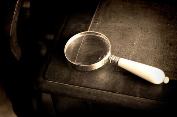 magnifying glass and closed book