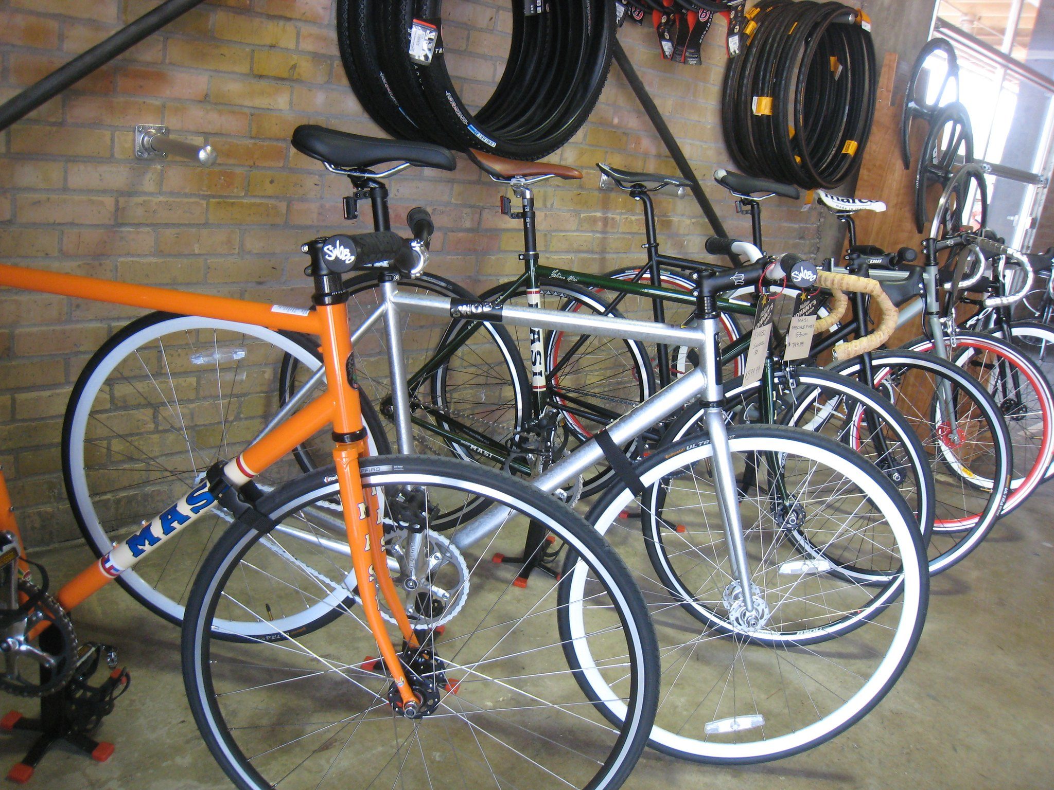 This photo shows a bunch of bikes in a bike shop.