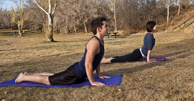 two people doing yoga poses
