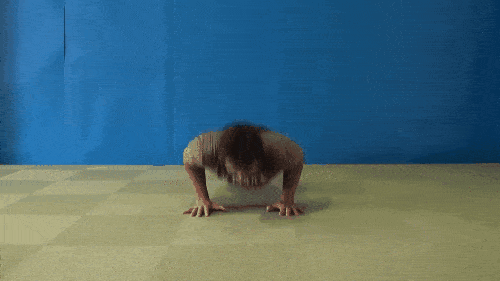 Someone doing a push-up by pushing off of the ground