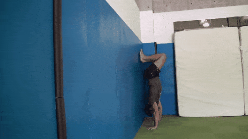  Doing a handstand push-up versus a wall