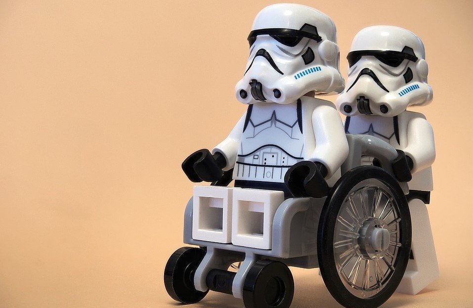 A stormtrooper in a wheelchair, who luckily has a friend to help with his DOMS.