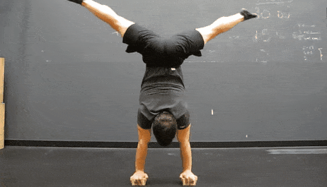 Coach Jim showing you the one-arm handstand.