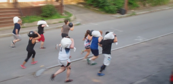 Running around the gym with sandbags is common at CrossFit gyms.