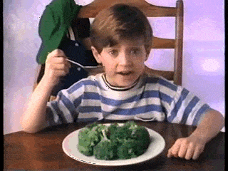A gif of Elijah Wood with cheese on his veggies