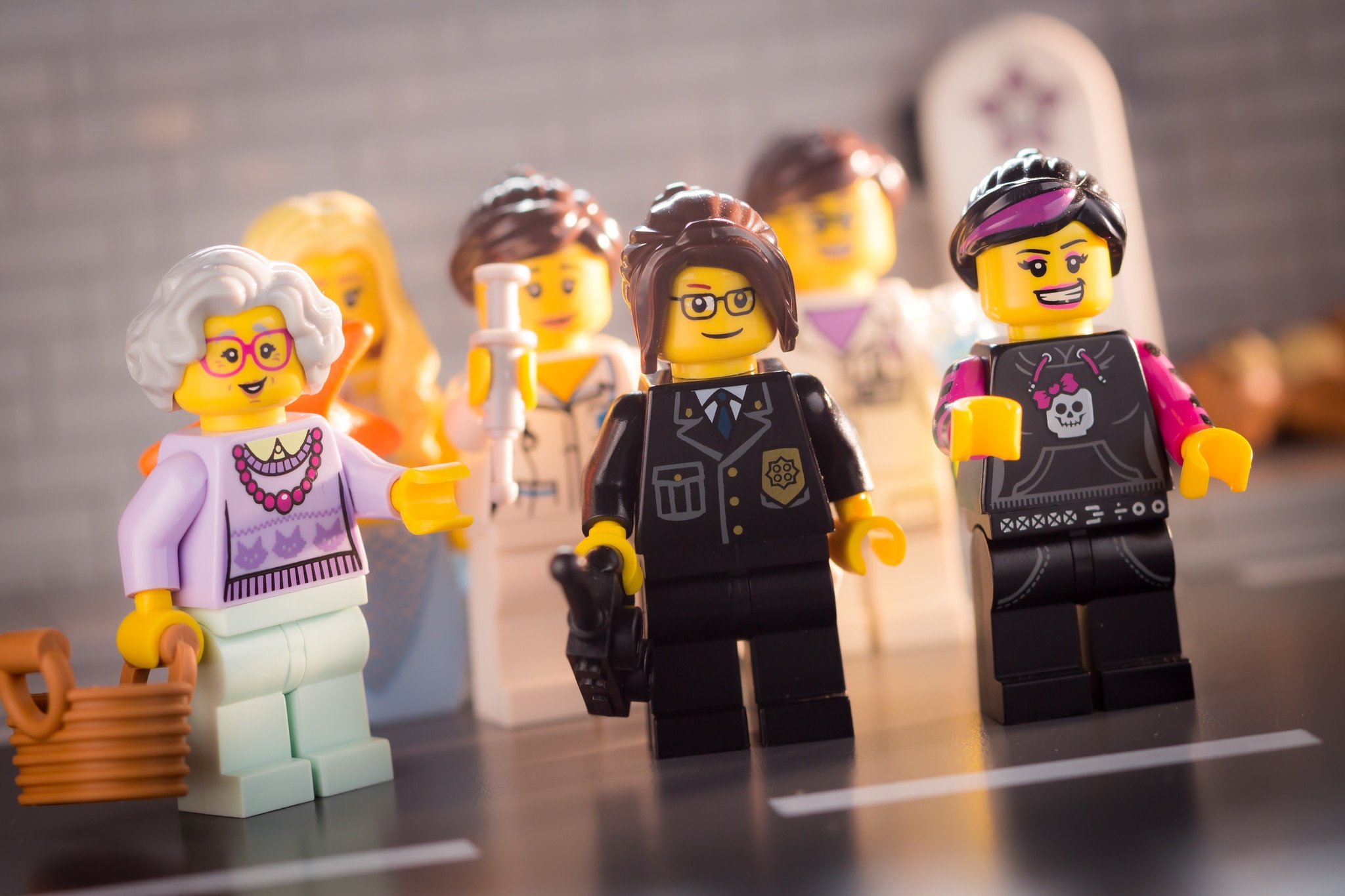 A group of variegated LEGO women ready to build muscle. 