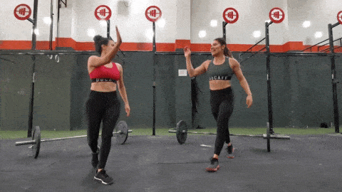 Two women high fiving at crossfit