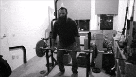 A man doing a deadlift from a rack, known as a rack pull deadlift. 