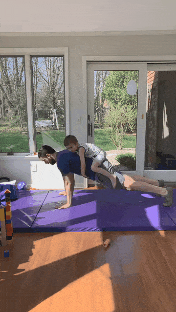 This is a gif of Matt doing push-ups, with his kid tying to his back.