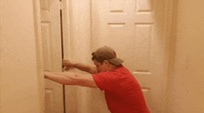 A gif of Coach Jim showing you a doorway row, our first pull-up alternative.