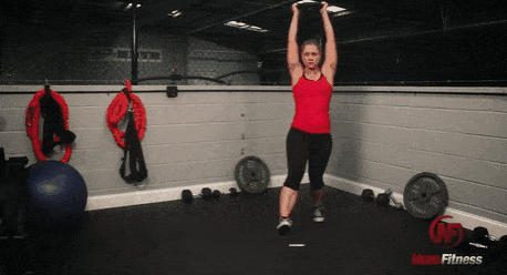 A gif of Coach Staci performing an overhead lunge