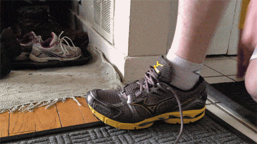 This gif shows someone in a lunge position, tying their shoe.