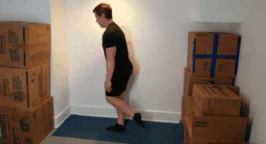 A gif of Coach Jim doing one-legged squats in a small space.