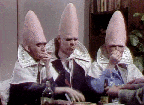 A gif of the Coneheads scarfing down while drunk