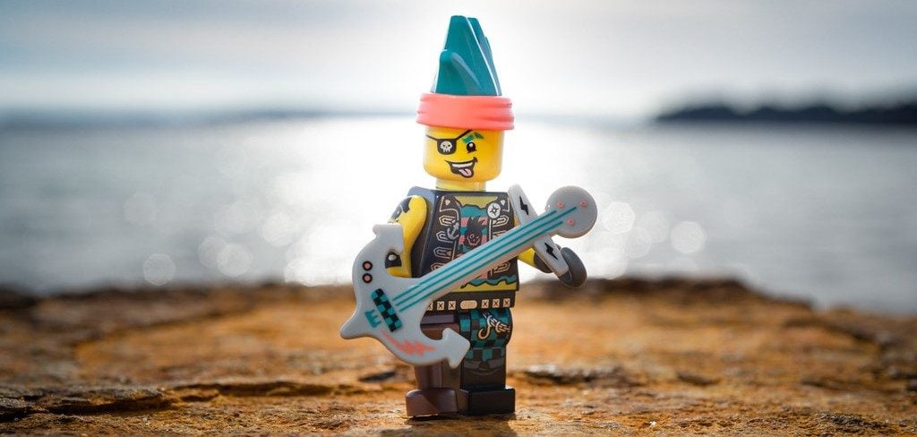 A photo of a LEGO who is part pirate and part musician.