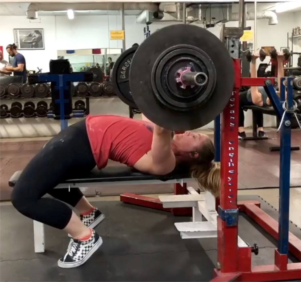 Coach Staci doing the bench press