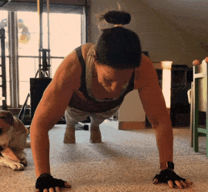 Megan doing a negative push-up with her dog