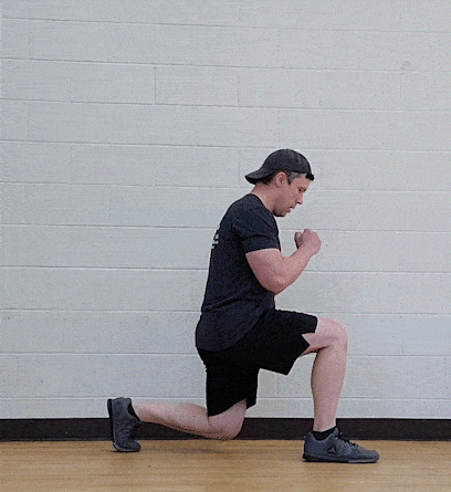 Coach Jim doing a jumping split squat: Get set just like a regular split squat - stepping out with one foot and sinking down. But now, instead of just split squatting up and down with the feet in place, you want to explode off the ground and switch feet in mid-air.
