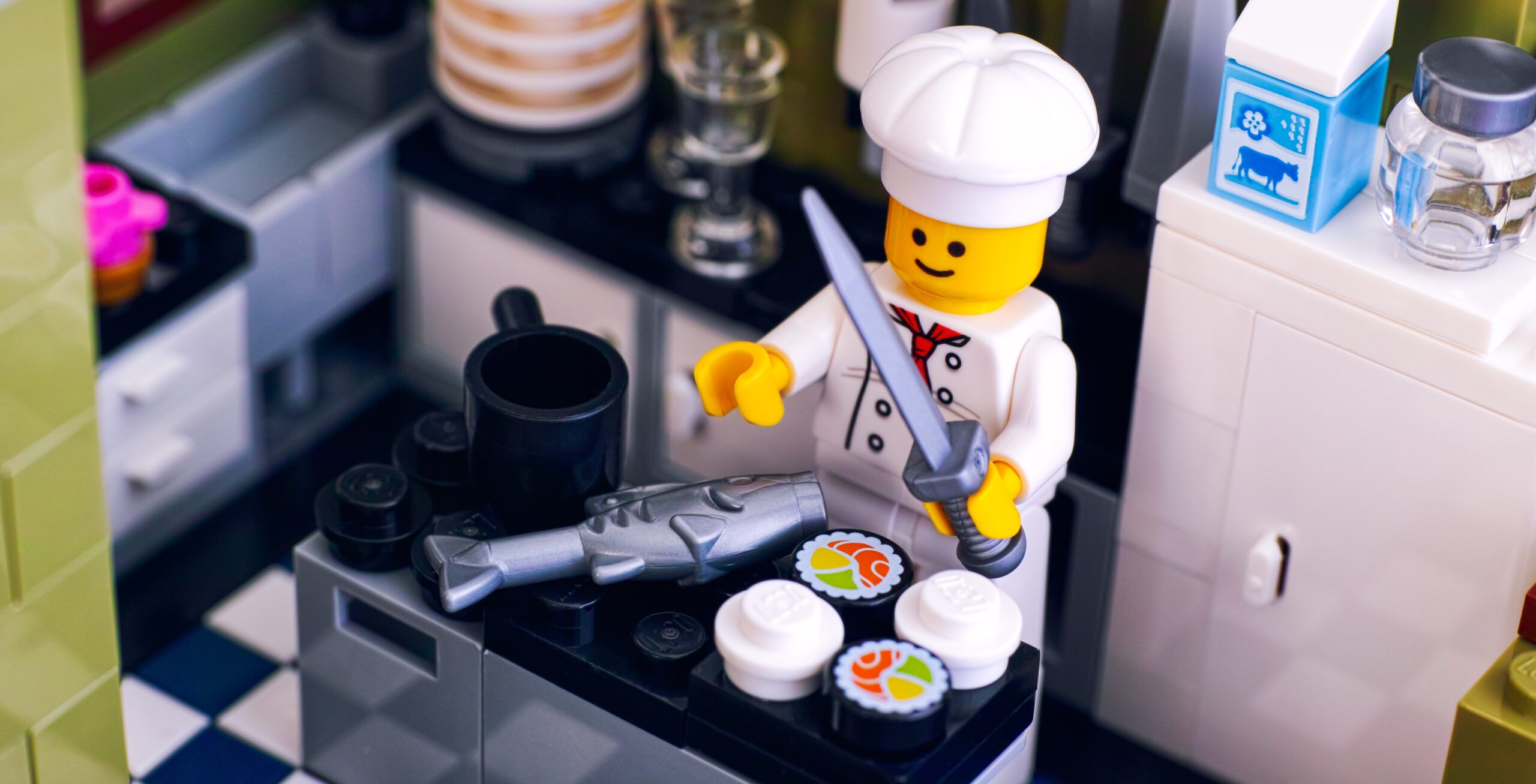 Lego chef cooking sushi and fish in the kitchen.