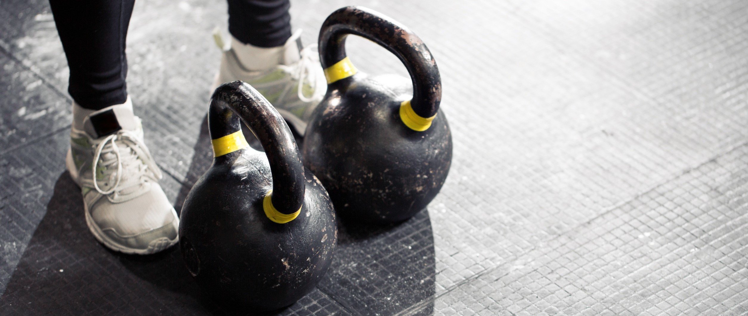 A woman with two kettlebells